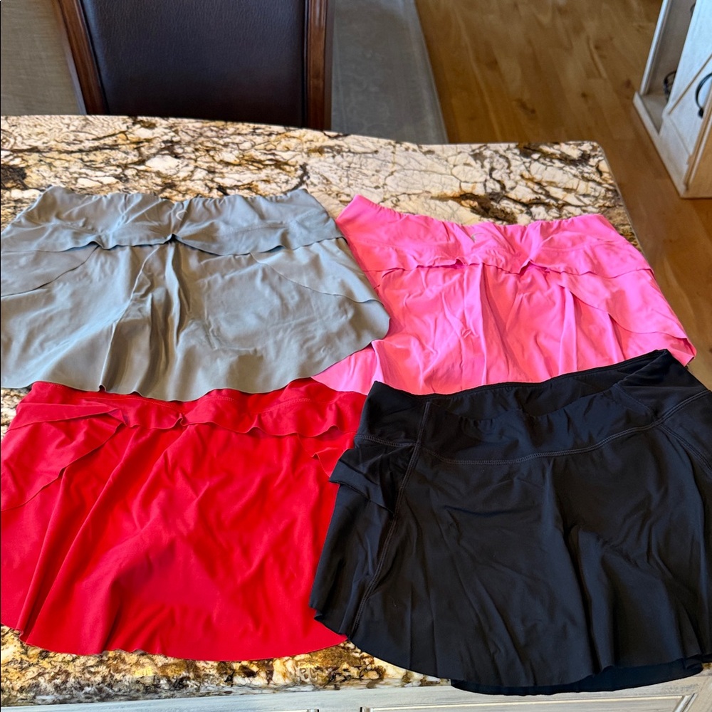 ZYIA Women's tennis skirts in Gray, Pink, Red, and Black